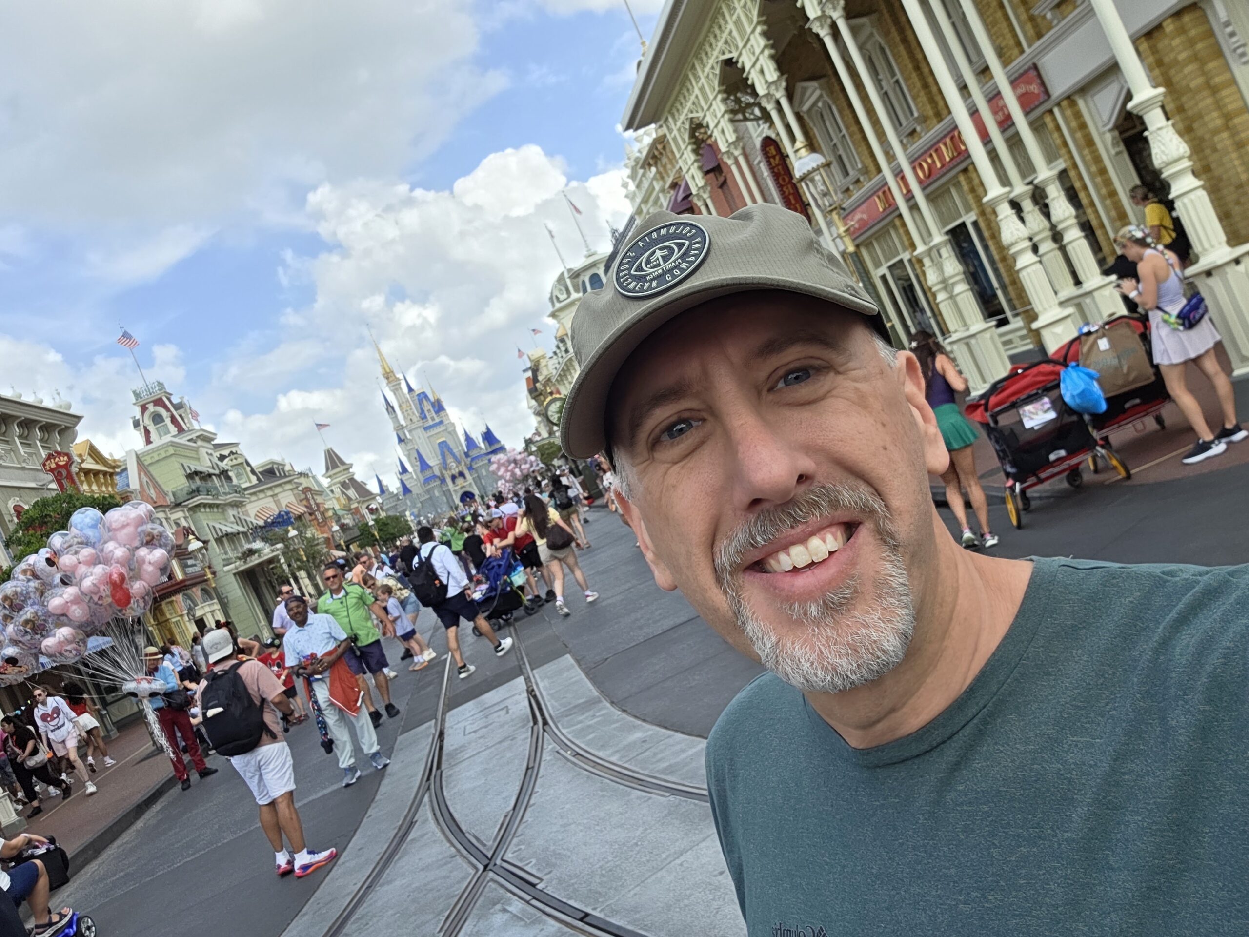 Alan smiling on Main Street, U.S.A., with Cinderella Castle behind him